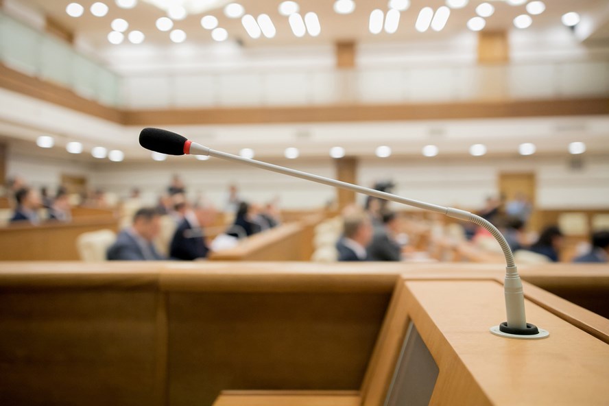 A picture of a microphone in a formal meeting