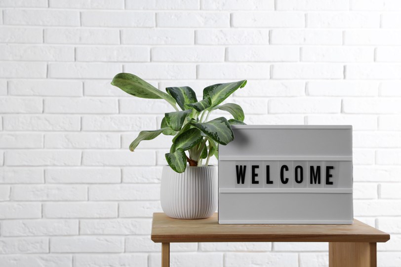 A sign on a table that says welcome