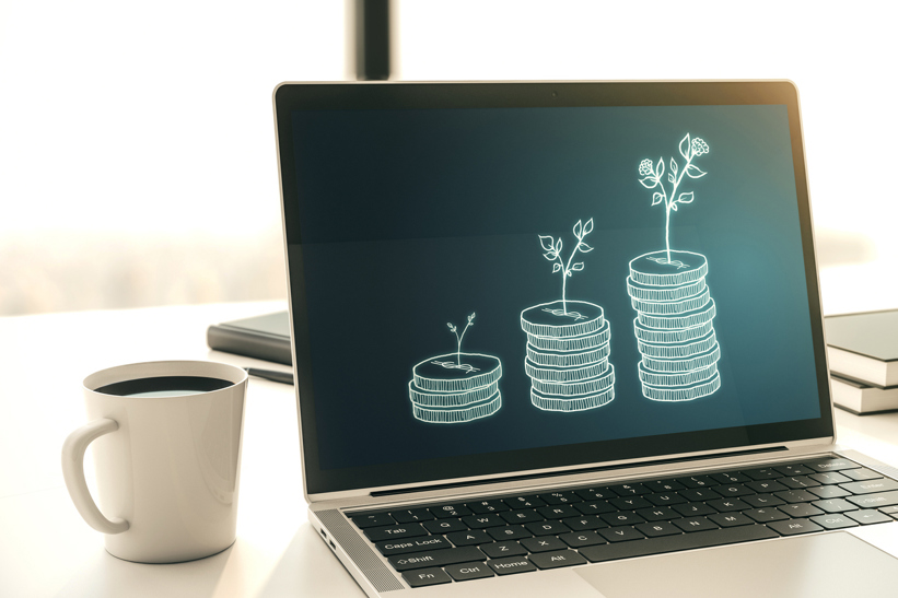 Laptop with piles of coins on screen